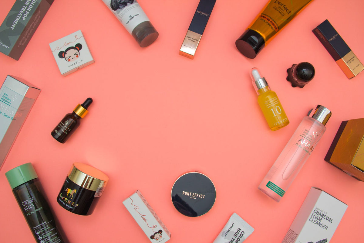 Skincare and beauty products on a coral background